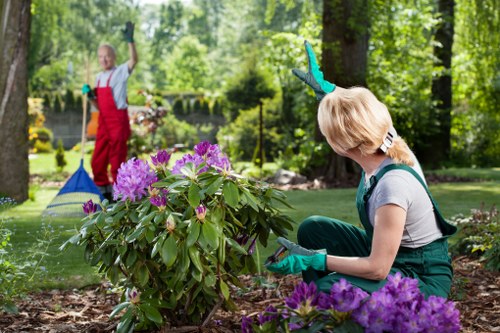 Gardeners Freezywater team sorting green waste for recycling